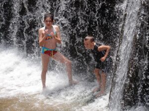 Children enjoying a day at the Paulina Plunge falls