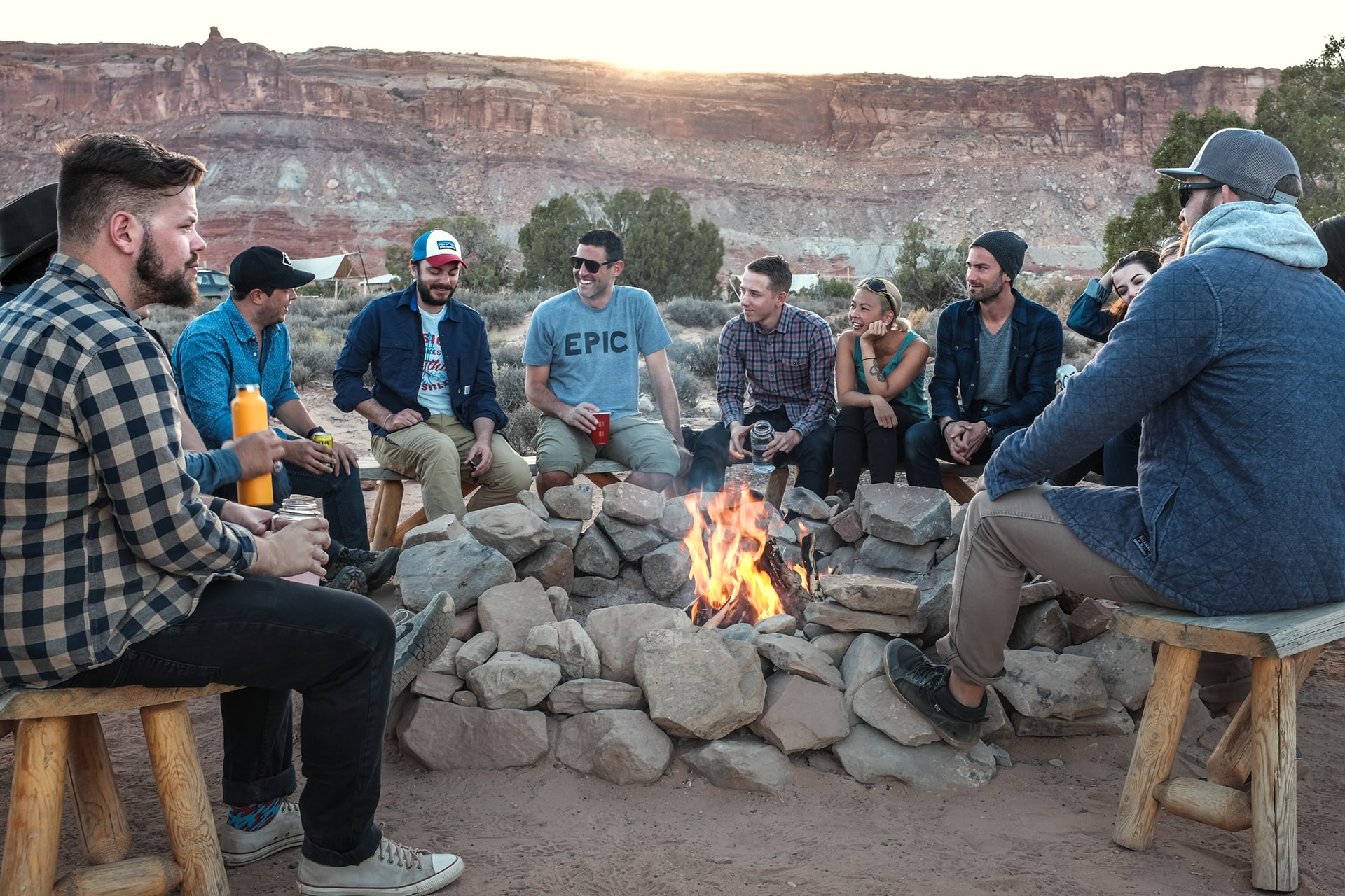 group of people sitting around a bonfire