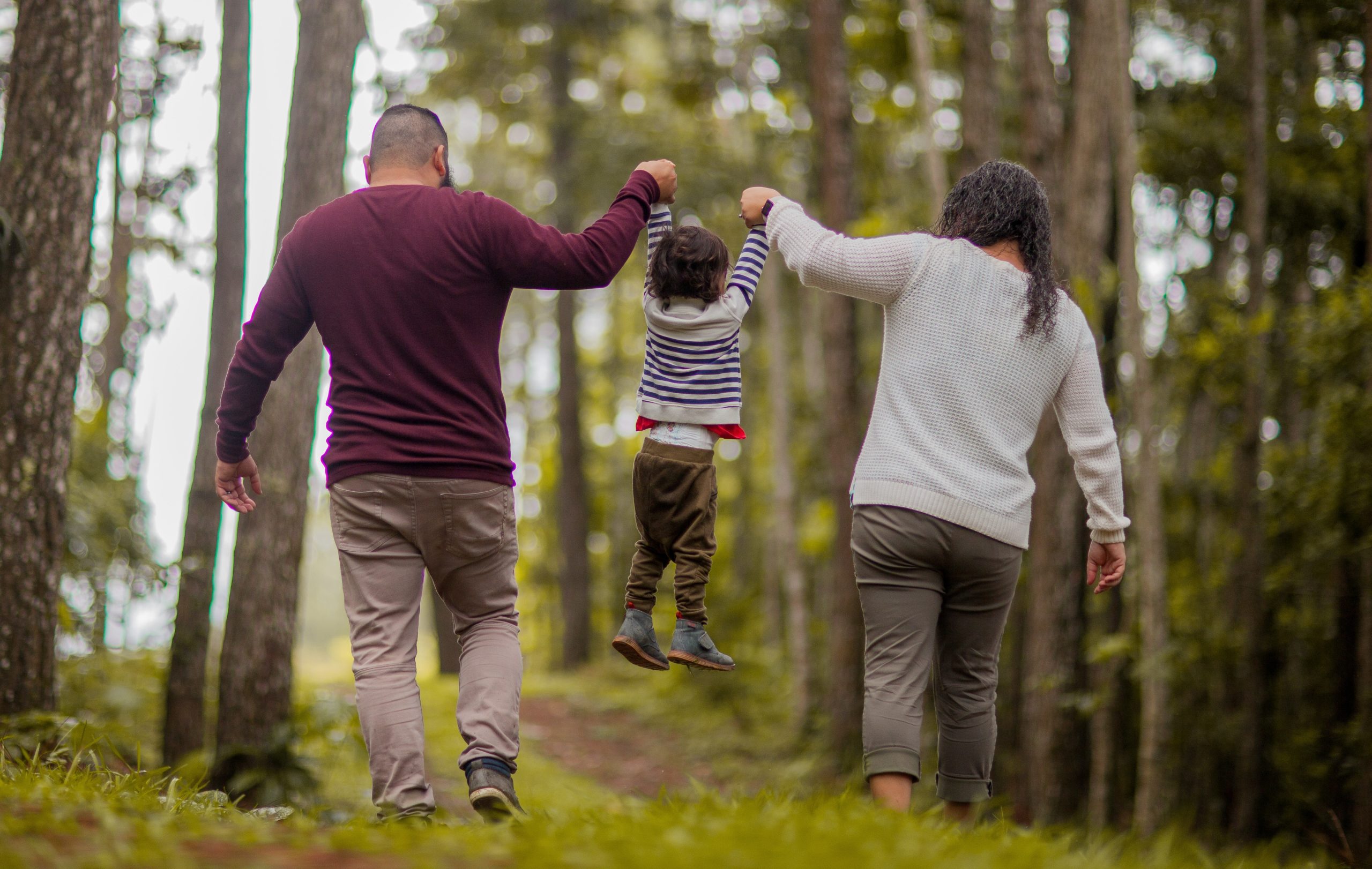 Family in a Forest Holding their Child up during a family getaway to Sunriver