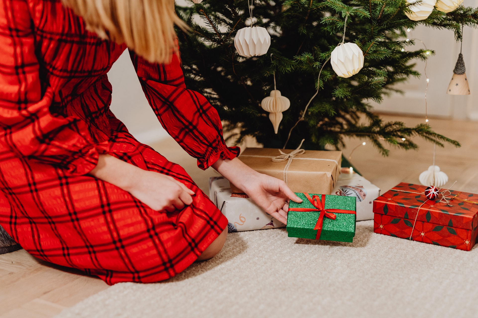 girl putting present under a tree